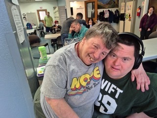 People smiling in a community center setting.