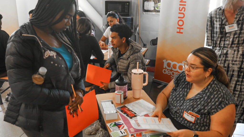 People discuss at housing information event.
